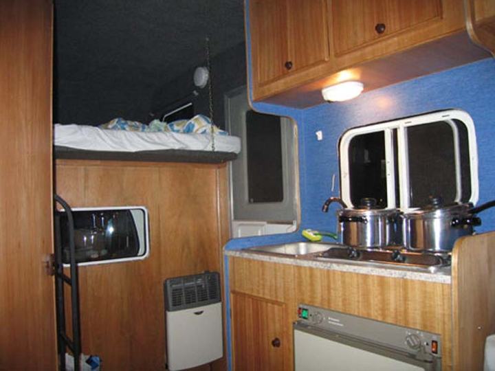 Interior: kitchen and bed above the cab