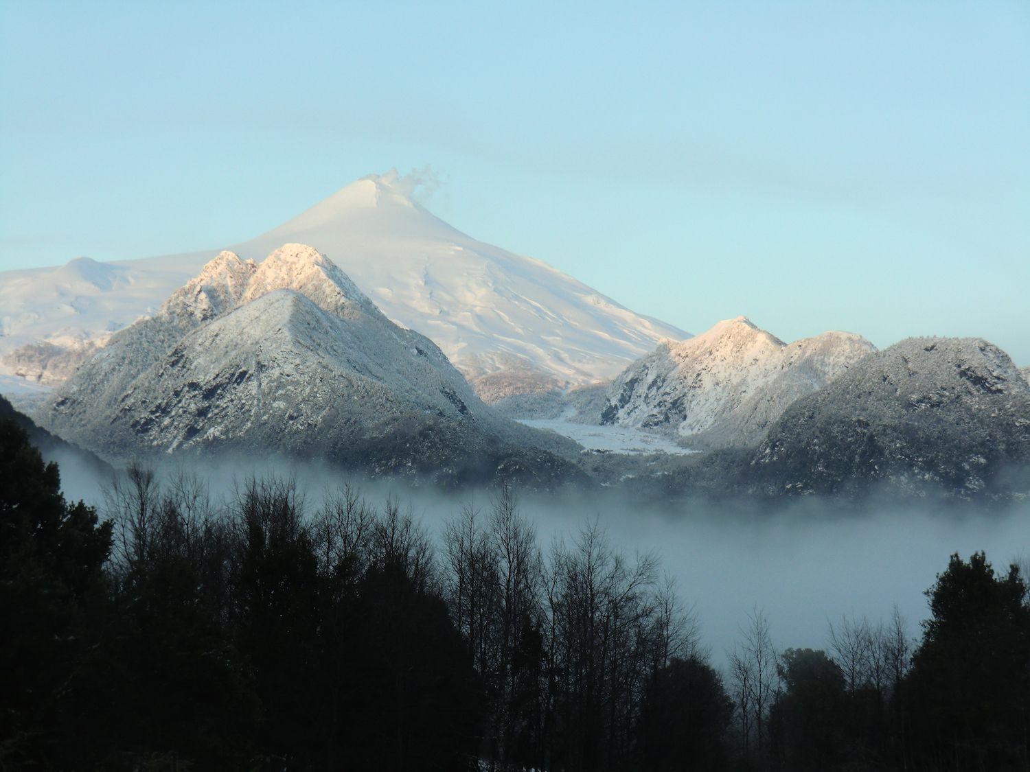 Villarrica volcano above the morning fog, seen from the land