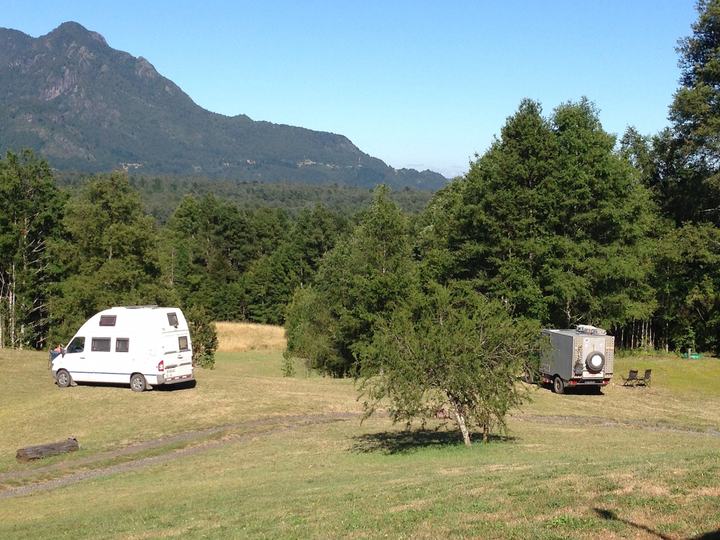 Two campers at the forest edge